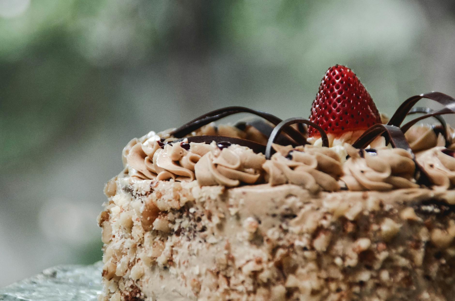shallow focus photography of cake with strawberry on top