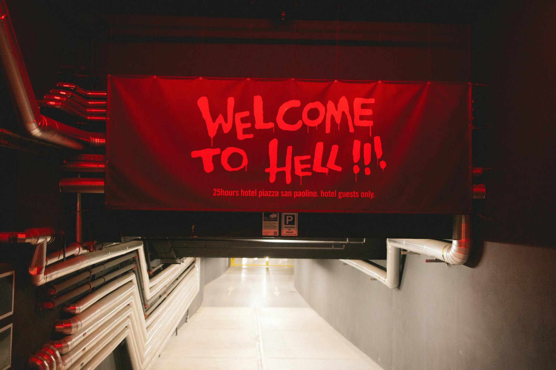 a red banner with the words welcome to hell hanging from the ceiling