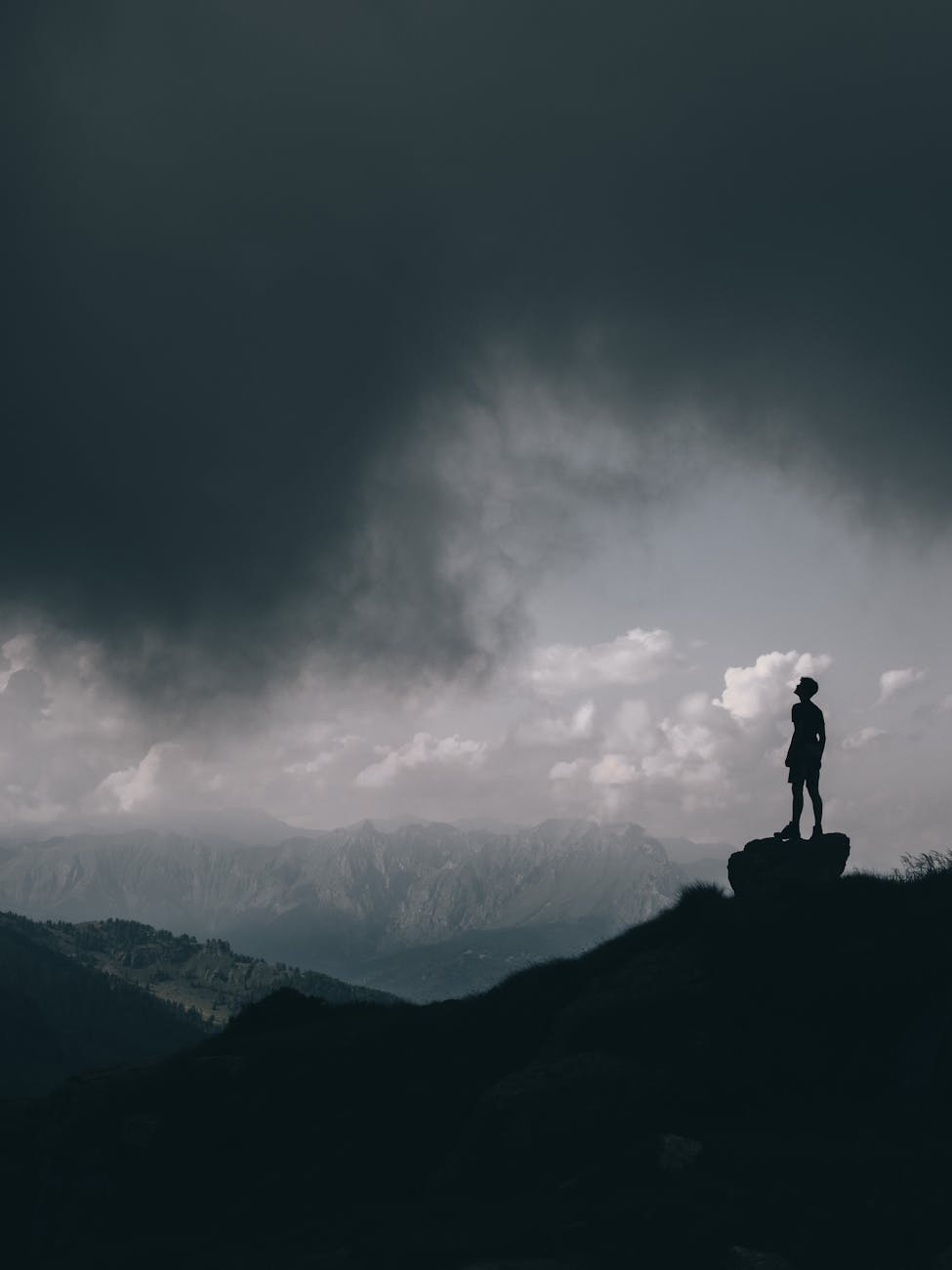 photo of man standing on rock
